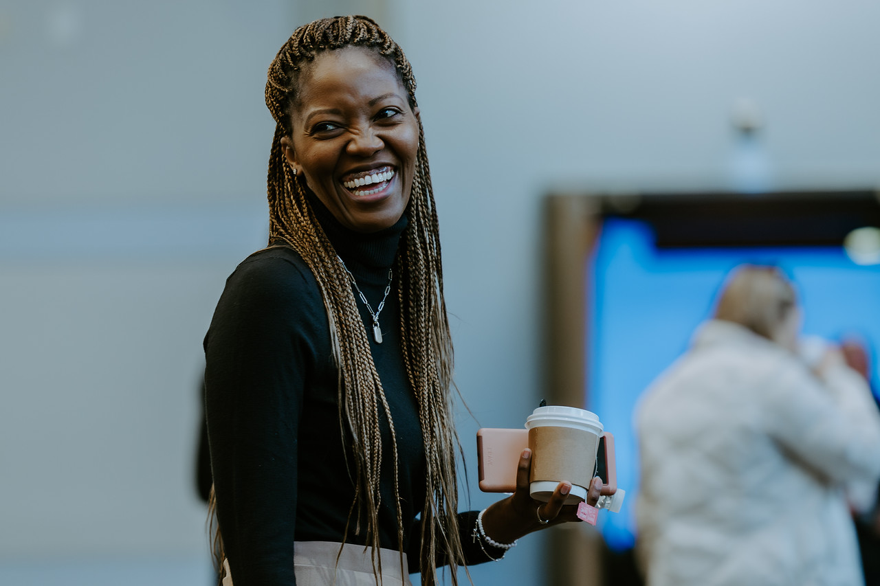 Woman smiling and holding coffee