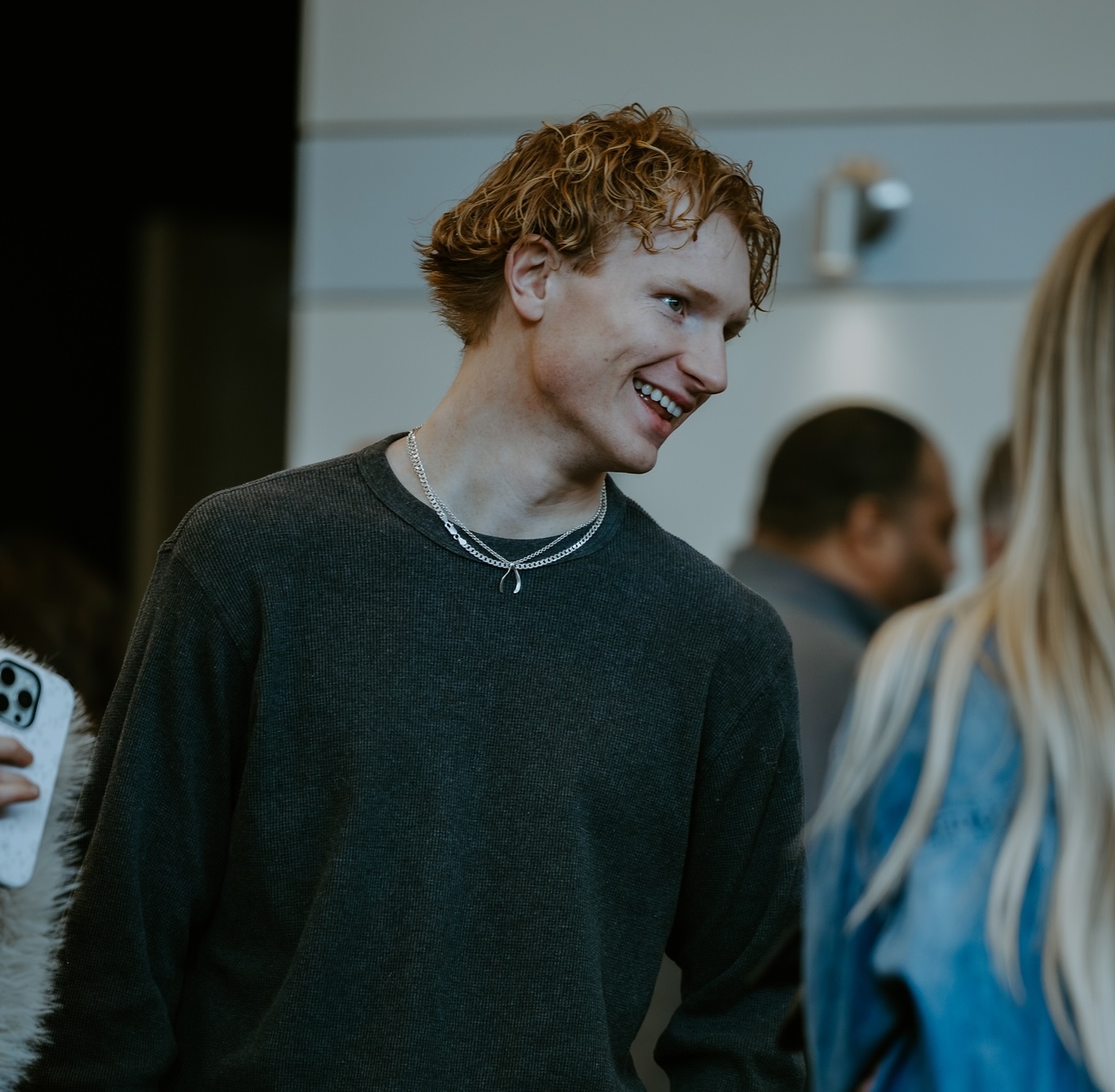 Young man looking to his left and laughing