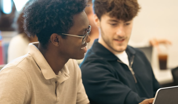 Two boys looking at a computer